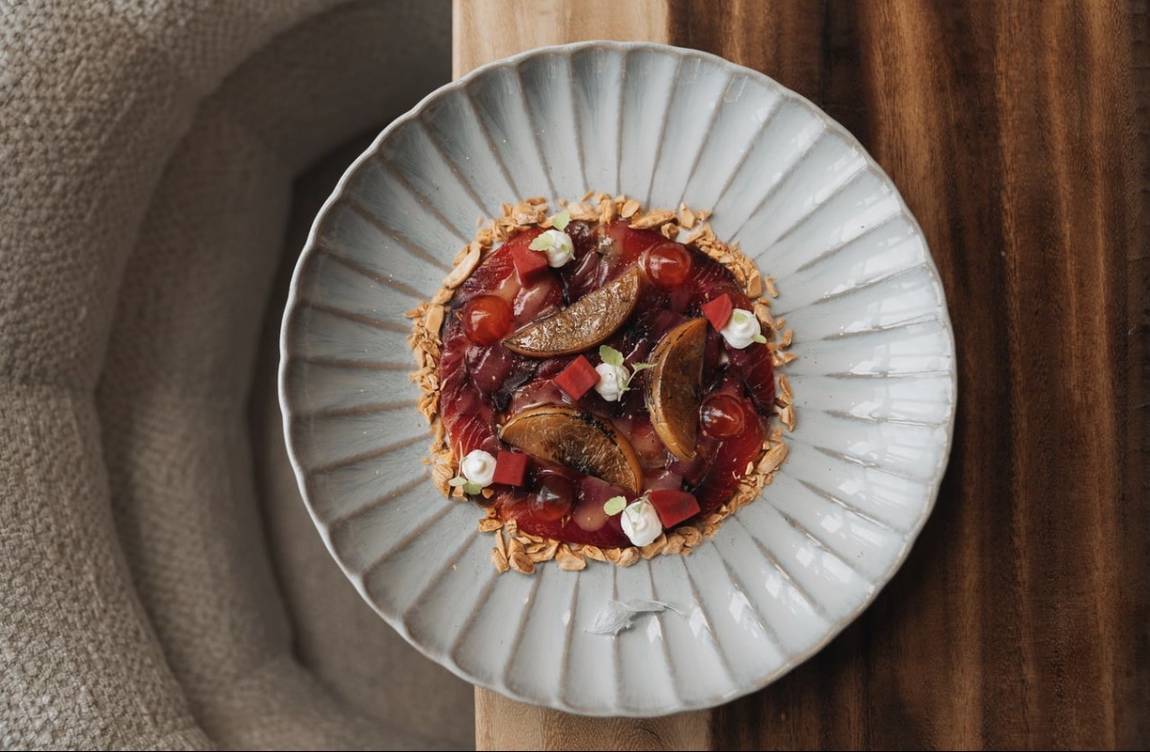 Carpaccio met vijg en granaatappel op een geribbeld bord